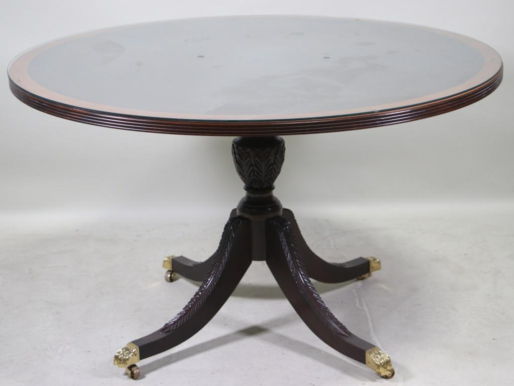 GEORGIAN STYLE MAHOGANY STICKLEY DINING TABLE: GEORGIAN STYLE MAHOGANY STICKLEY DINING TABLE WITH GLASS TOP WITH FOUR CARVED SPLAYED LEGS ON CASTERS. Height: 30 in. by Width: 50 in. by Depth: 50 in.