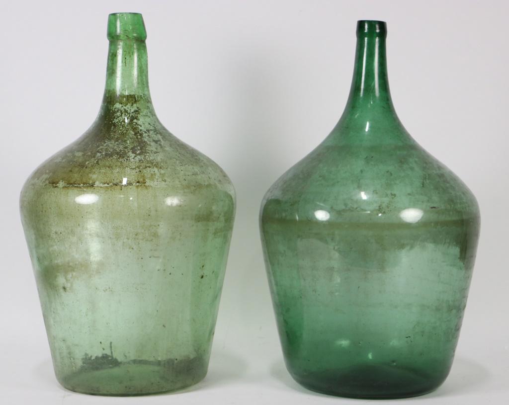 PAIR OF VINTAGE DEMIJOHN WINE JUGS: PAIR OF VINTAGE DEMIJOHN WINE JUGS. Height: 19 1/2 in. by Width: 12 in. by Depth: 12 in.