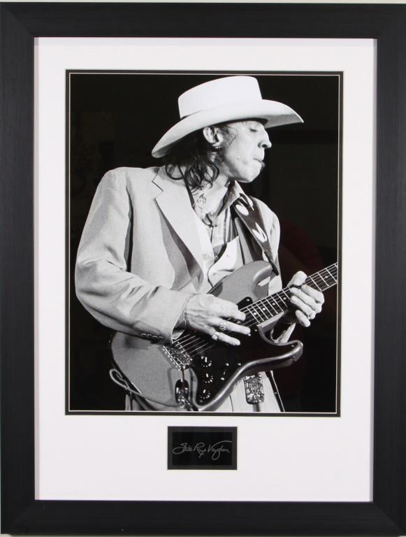 FRAMED STEVIE RAY VAUGHAN PHOTO W/PRINT AUTOGRAPH: FRAMED STEVIE RAY VAUGHAN PHOTO WITH PRINTED AUTOGRAPH FROM A PLATE. Height: 30 in. by Width: 23 1/2 in. by Depth: 1 IN.