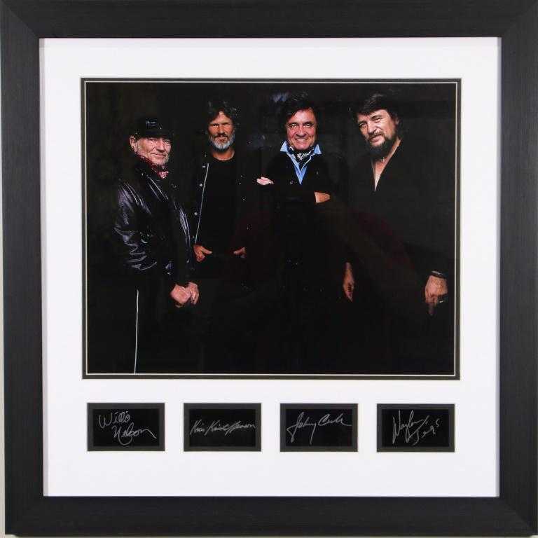FRAMED THE HIGHWAYMEN PHOTO W/PRINTED AUTOGRAPHS: FRAMED THE HIGHWAYMEN PHOTO SIGNED IN PLATE FEATURING THE SIGNATURES OF WILLIE NELSON, JOHNNY CASH, WAYLON JENNINGS & KRIS KRISTOFERSON. Height: 27 1/2 in. by Width: 27 1/2 in.
