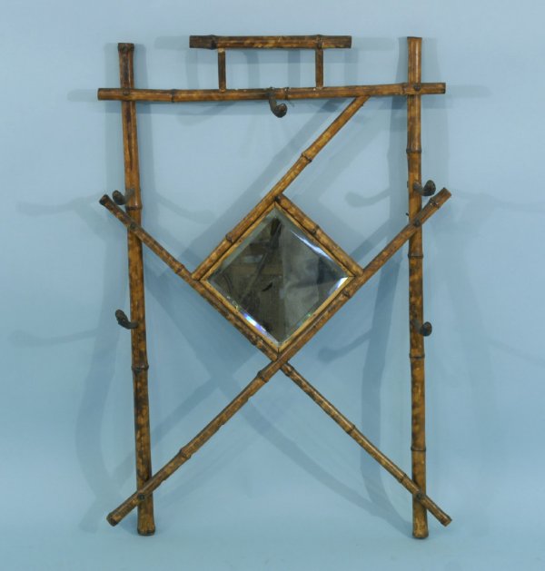 A BURNT BAMBOO HALL TREE WITH BEVELED MIRROR: A BURNT BAMBOO HALL TREE WITH A BEVELED MIRROR. Height: 40 in. by Width: 28 in. by Depth: 8 in.