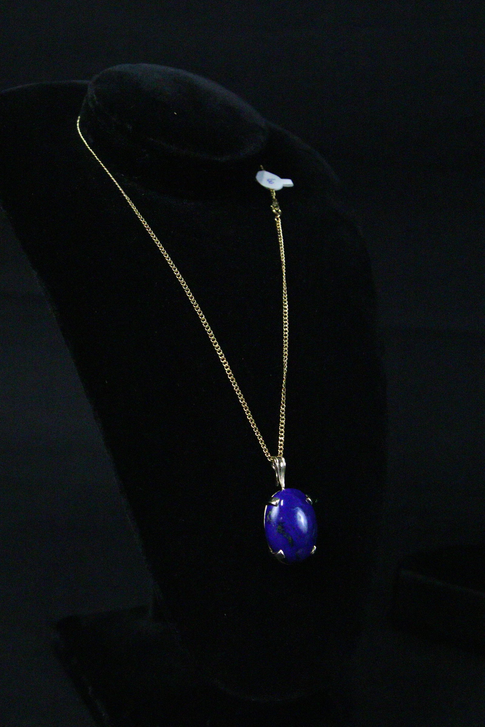 14KT YELLOW GOLD LAPIS LAZULI PENDANT ON NECKLACE: A NATURAL LAPIS LAZULI STONE OF AFGANISTAN ORIGIN, SET IN A 14KT. YELLOW-GOLD PENDANT. THIS BEAUTIFUL LAPIS HAS A DEEP BLUE COLORATION WITH FLECKS OF PYRITE. THIS OVAL DOMED STONE MEASURES 27MM. LONG 
