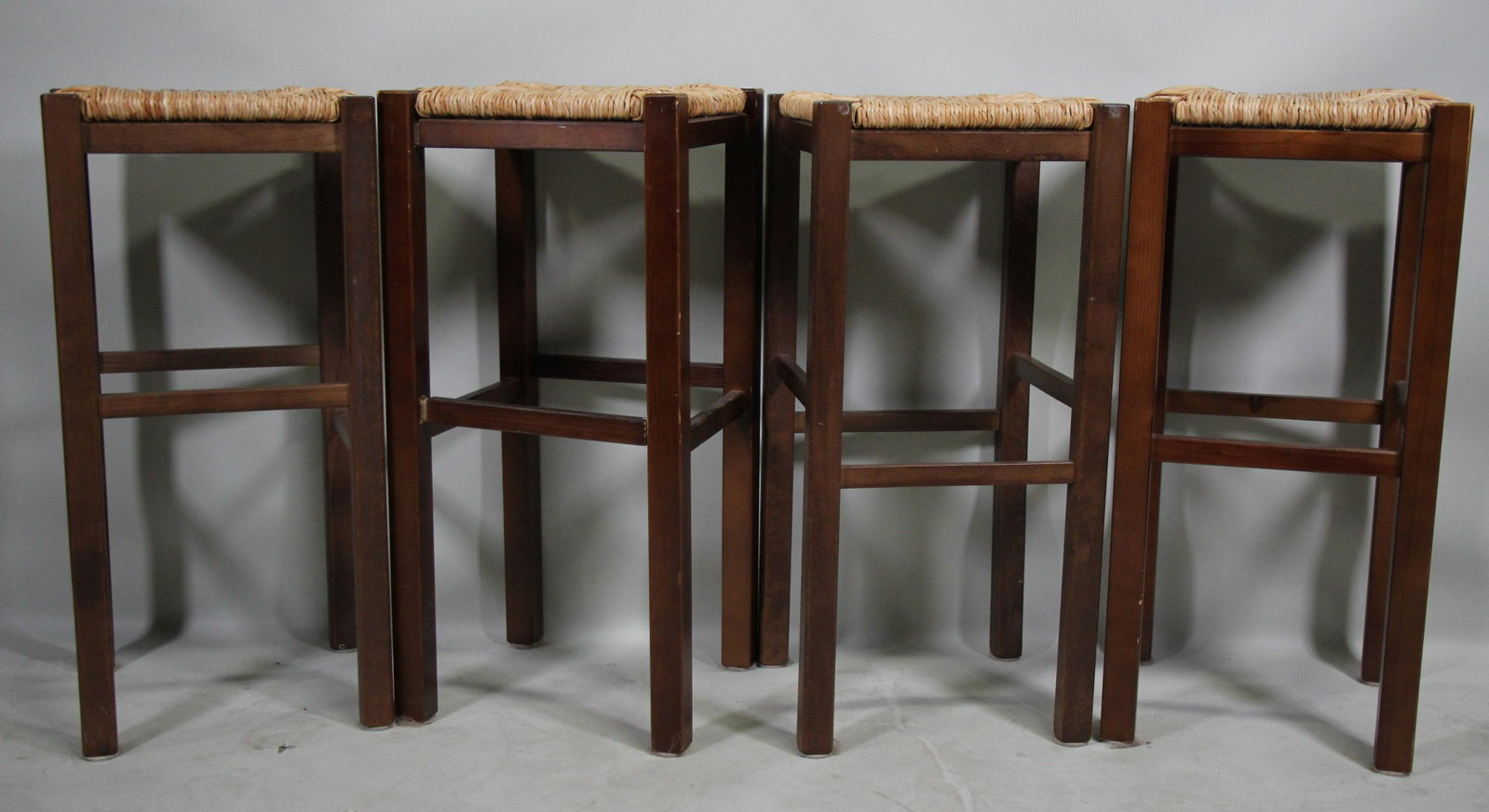 LOT OF FOUR BAR STOOLS WITH RUSH SEATS: LOT OF FOUR BAR STOOLS WITH RUSH SEATS. Height: 29 in. by Width: 14 in. by Depth: 14