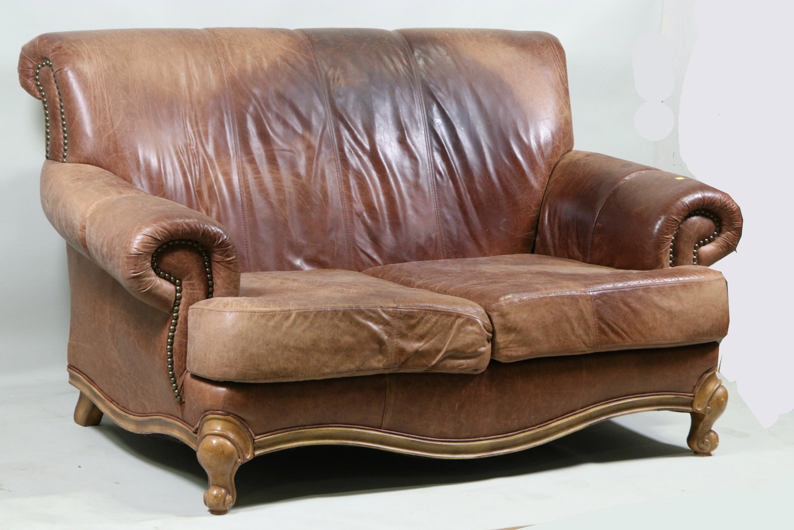 LEATHER TWO CUSHION HIGH BACK SOFA. WORN LEATHER: LEATHER TWO CUSHION HIGH BACK SOFA. WORN LEATHER, SOLD AS IS. Height: 38 in. by Width: 74 in. by Depth: 40