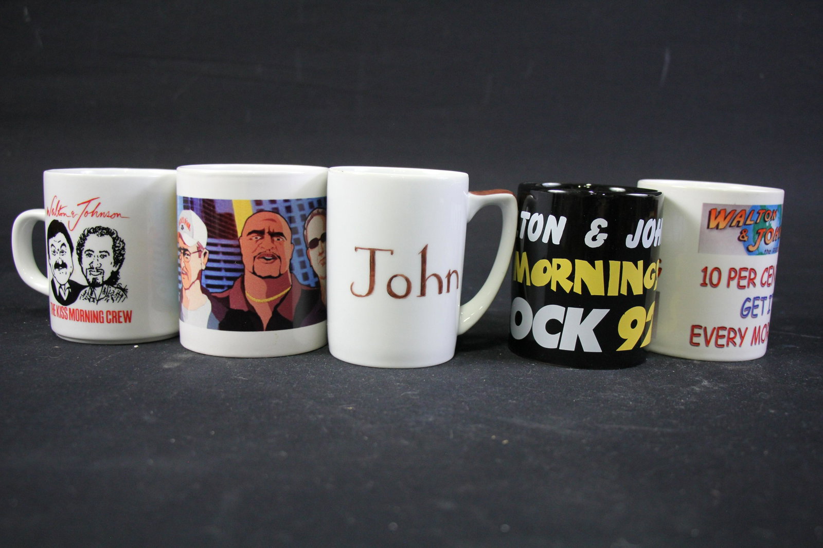 SET OF 5 WALTON & JOHNSON MUGS: SET OF 5 WALTON & JOHNSON MUGS:(1) WALTON & JOHNSON "10% GET IT EVERY MORNING" MUG(2) WALTON & JOHNSON ROCK 92.3 MUG(3) JOHN WALTON MUG(4) KISS 106FM MUG(5) MORNING CREW MUG - **FROM THE JOHN WALTON E