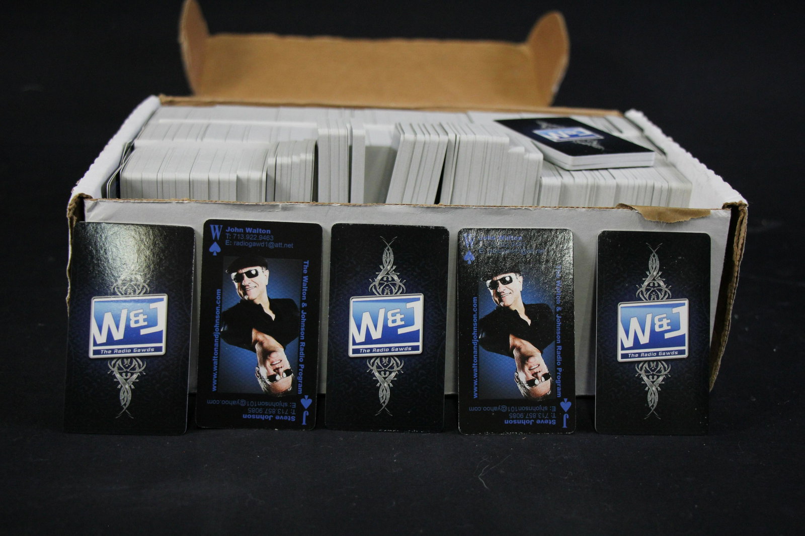 BOX OF JOHN WALTON'S PERSONAL ITEMS: BOX LOT OF JOHN WALTON ITEMS - (1) BOX OF WALTON & JOHNSON BUSINESS CARDS (PLAYING CARD STYLE); (2) SET OF ROCK 101 KLOL STICKERS; (3) SET OF TWO HD HOG RIDER STATUES - MADE BY A LISTENER; (4+5) INFID