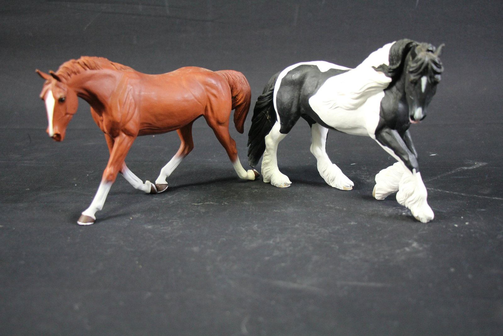 SET OF TWO HORSE FIGURINES: TWO HORSE FIGURINES - FREISIAN PINTO CROSS & REDD QUARTER HORSE - **FROM THE JOHN WALTON ESTATE** Height: 6 in. by Width: 12 in. by Depth: 4