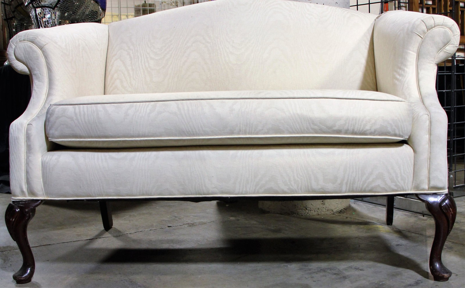 IVORY FABRIC UPHOLSTERED SETTEE: IVORY FABRIC UPHOLSTERED SETTEE. Height: 32 in. by Width: 52 in. by Depth: 36