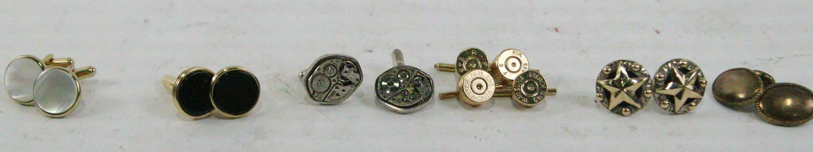 LOT OF 14PCS PERSONAL JEWELRY ITEMS: LOT OF 14PCS PERSONAL JEWELRY ITEMS: TWO PAIRS OF SHELL CASINGS GOLD CUFFLINKS, PAIR OF BULOVA WATCH MECHANISM SILVER CUFFLINKS, PAIR OF GOLD ONYX CUFFLINKS, PAIR OF GOLD PEARL CUFFLINKS, PAIR OF STER