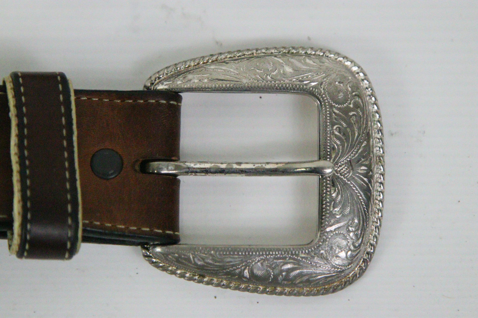 LOT OF THREE PERSONAL ITEMS - WESTERN BELTS: LOT OF THREE PERSONAL ITEMS - WESTERN BELTS: (1) LUCHESE BLACK LEATHER WITH BLACK OSTRICH ACCENTS AND SILVER STAMPED BUCKLE; (2) TONY LLAMA BLACK LEATHER W/CRÈME LEATHER ACCENTS & SILVER BUCKLE AND C