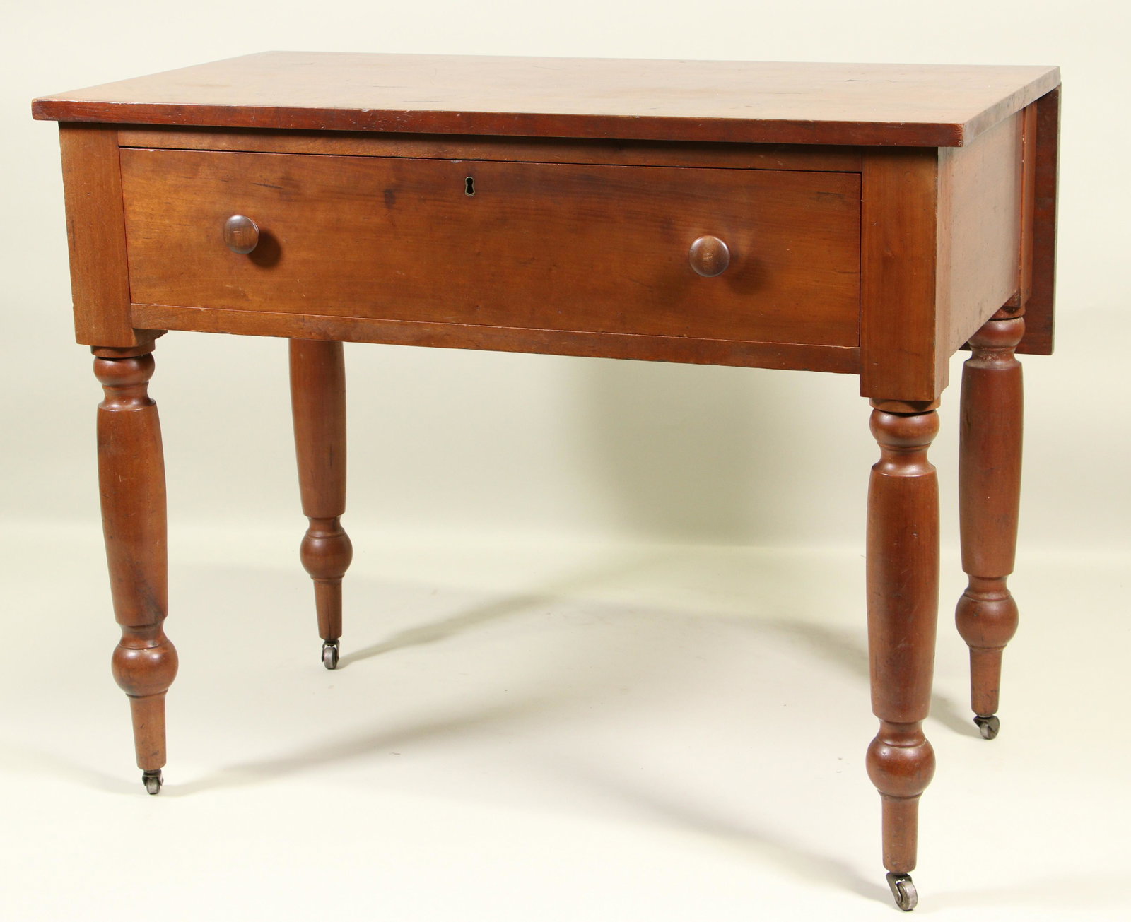 AMERICAN MAHOGANY DROP LEAF WORK TABLE: AMERICAN MAHOGANY DROP LEAF WORK TABLE WITH ONE DRAWER ON TURNED LEGS. Height: 31 in. by Width: 38 in. by Depth: 22 & 33 in.