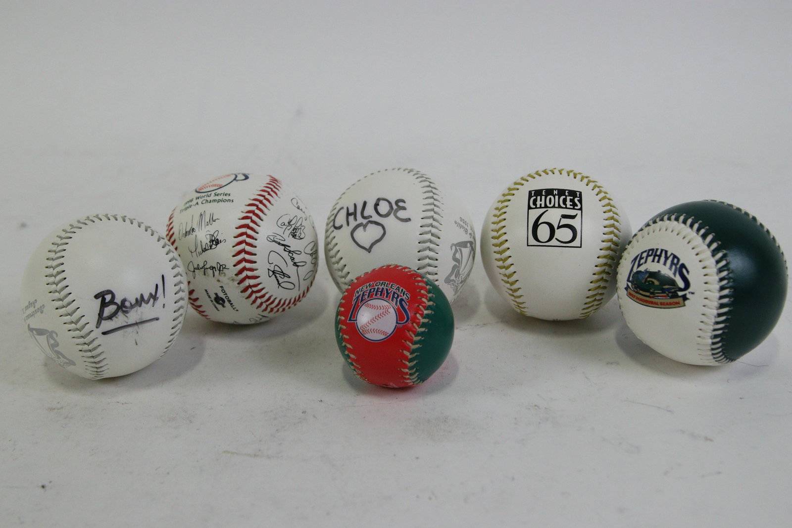 LOT OF SIX NEW ORLEANS ZEPHYRS BASEBALLS: LOT OF SIX NEW ORLEANS ZEPHYRS BASEBALLS -(1) 1991 INAUGURAL SEASON; (2) 1998 WORLD SERIES AAA CHAMPIONS WITH 25 TEAM SIGNATURES; (3) SIGNED "CHLOE & BOUDREAUX" MASCOTS; (4) SIGNED "CHLOE & BOUDREAUX"