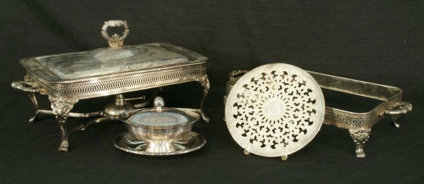 BOX LOT OF REED & BARTON AND OTHER SILVERPLATE: BOX LOT OF ASSORTED SILVERPLATE ITEMS. 1 LIDDED GRAVY BOAT MARKED REED & BARTON, 1 RECTANGULAR CHAFING DISH STAND WITH NO PYREX DISH (4 in. X 19 in. X 9 1/2 in.), 1 RECTANGULAR STAND WITH NO PYREX DIS