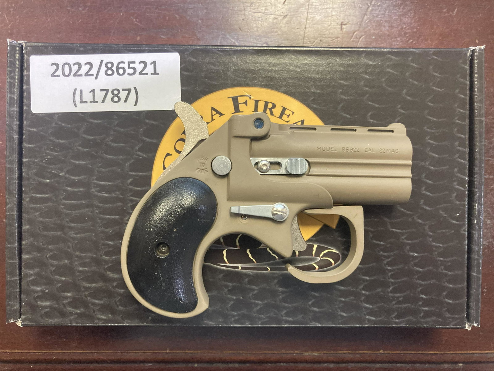 COBRA BIG BORE DERRINGER .22WMR PISTOL (NEW): COBRA BIG BORE DERRINGER .22WMR PISTOL (NEW) - TAN FINISH W/BLACK GRIPS, 2.75in BARREL, & 4.65in OALCALIBER: .22WMRSERIAL# BT016492NEW FIREARM(L1787) in. by Depth: 1