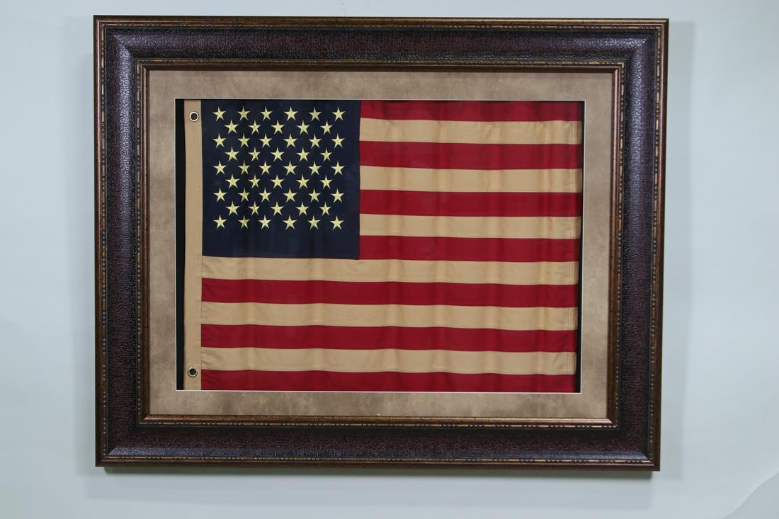FRAMED WAVY USA FLAG: FRAMED WAVY USA FLAG Height: 38 in. by Width: 49 in. by Depth: 1