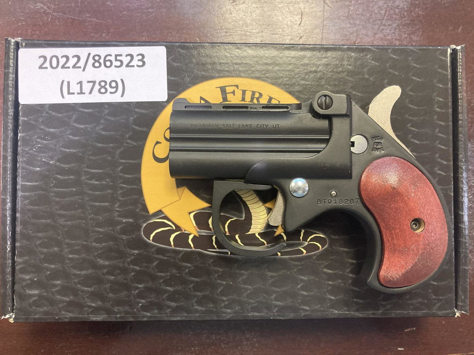 COBRA BIG BORE DERRINGER .22WMR PISTOL (NEW): COBRA BIG BORE DERRINGER .22WMR PISTOL (NEW) - BLACK FINISH W/ROSEWOOD GRIPS, 2.75in BARREL, & 4.65in OALCALIBER: .22WMRSERIAL# BT018527NEW FIREARM(L1793) in. by Depth: 1