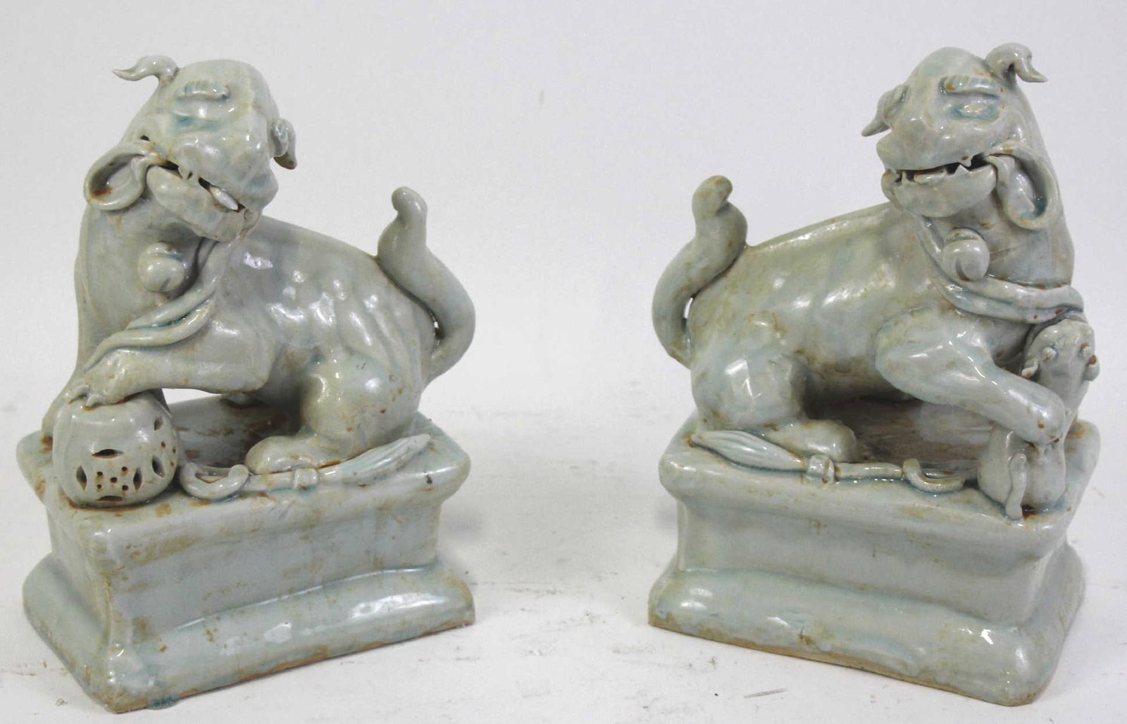 PAIR OF GLAZED PEKING STONEWARE FOO DOGS: PAIR OF VINTAGE PEKING SOAPSTONE FOO DOGS. Height: 12 in. by Width: 9 in. by Depth: 5 in.
