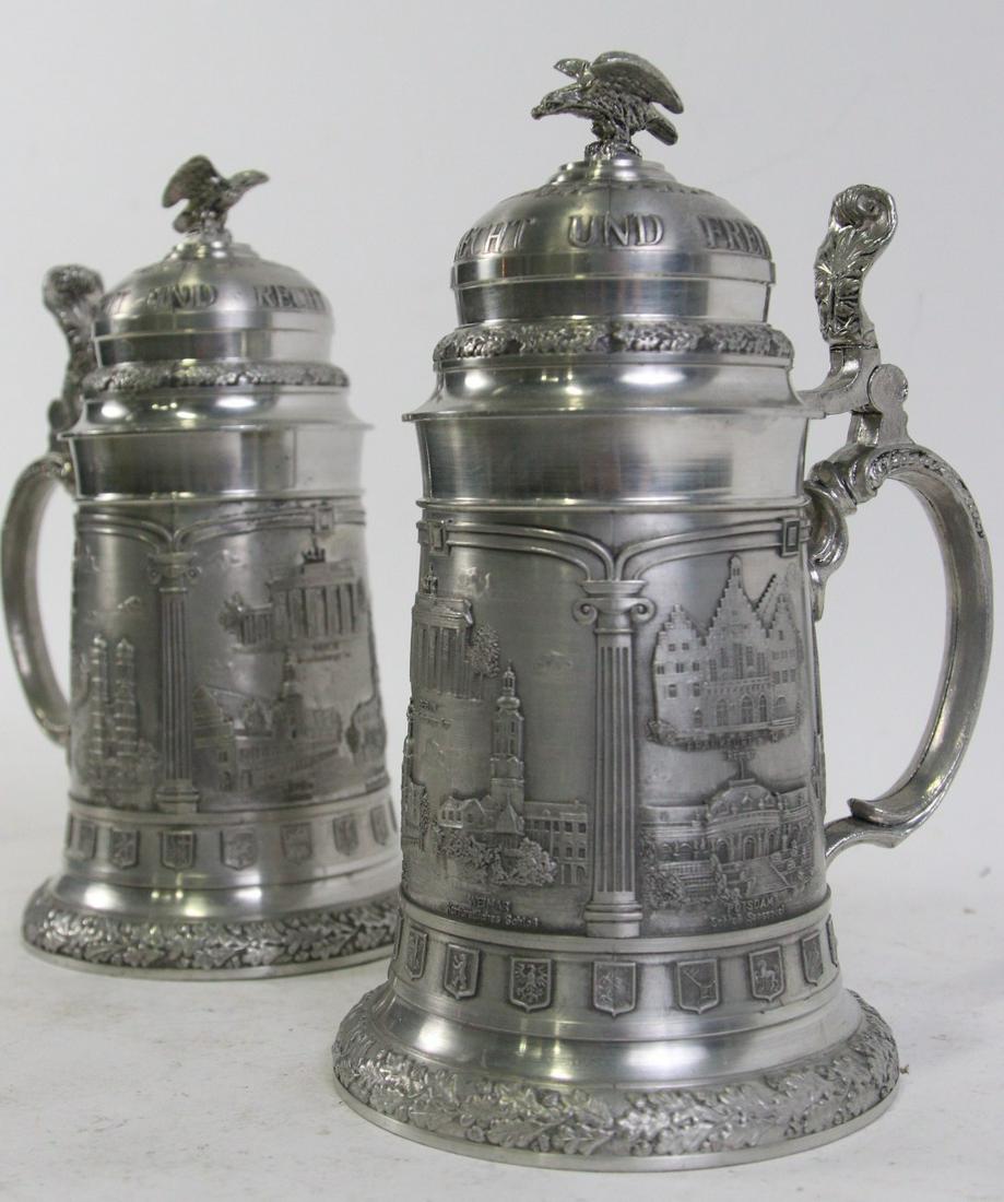 PAIR OF METAL BEER STEINS: PAIR OF METAL BEER STEINS. Height: 9.5 in. by Width: 5.5 in. by Depth: 5.5