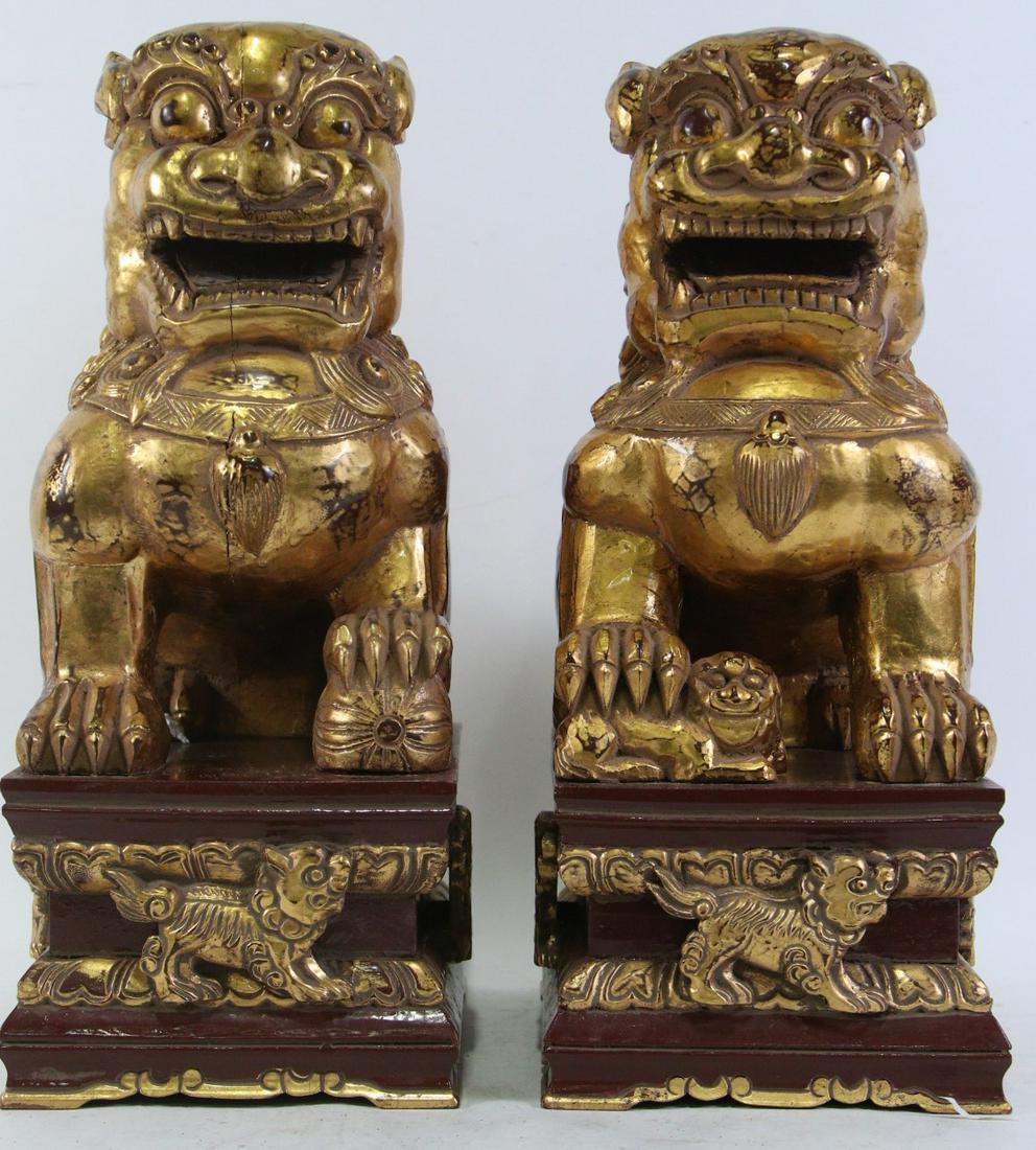 PAIR OF VINTAGE CARVED & GILDED FOO DOGS: PAIR OF VINTAGE CARVED & GILDED FOO DOGS. Height: 19.5 in. by Width: 8 in. by Depth: 11