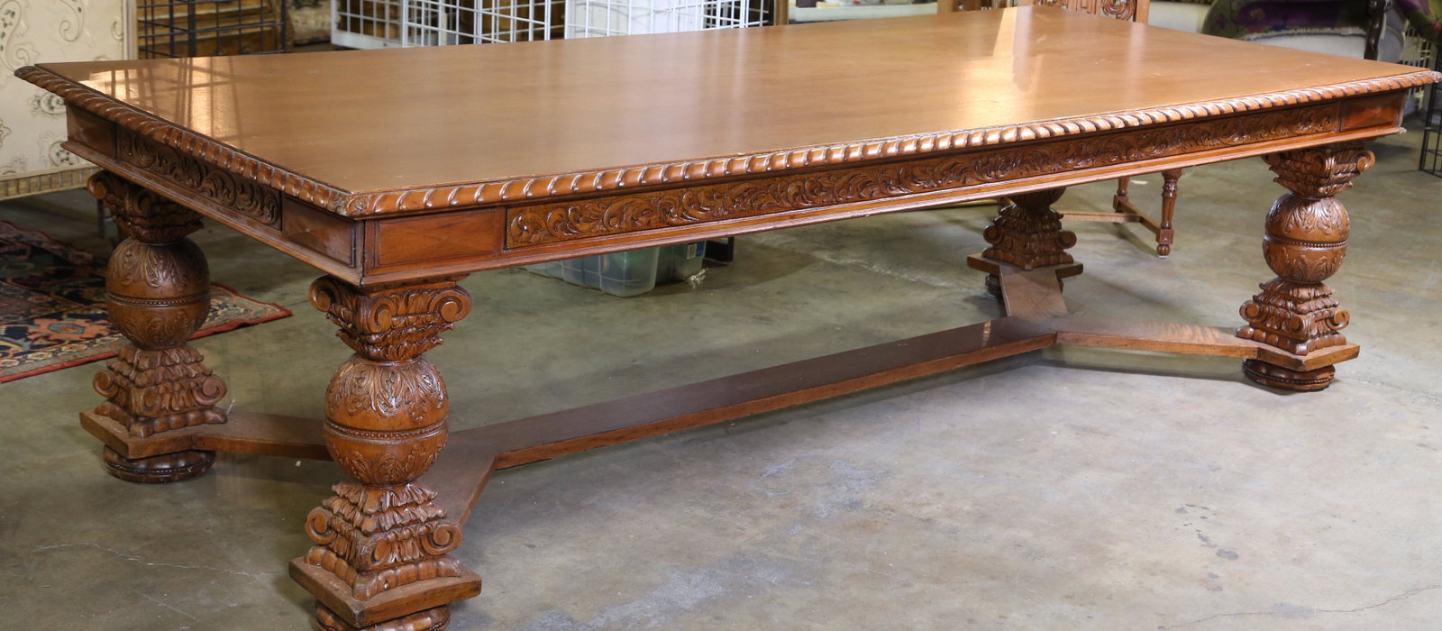 RENAISSANCE REVIVAL STYLE CARVED DINING TABLE: CARVED DINING TABLE. FOUR LARGE LEGS JOINED BY CROSSED STRETCHER. IN THE RENAISSANCE REVIVAL MANNER. Height: 30 in. by Width: 108 in. by Depth: 36