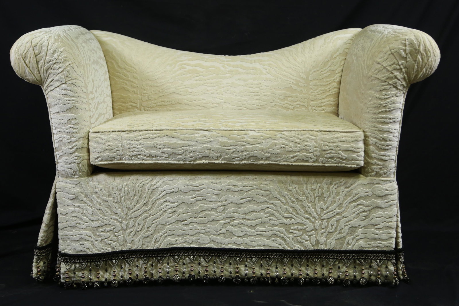 WHITE CUT VELVET FAUX TIGER LOVE SEAT: WHITE CUT VELVET FAUX TIGER LOVE SEAT AND TASSELED SKIRT. Height: 36.5 in. by Width: 58.5 in. by Depth: 32
