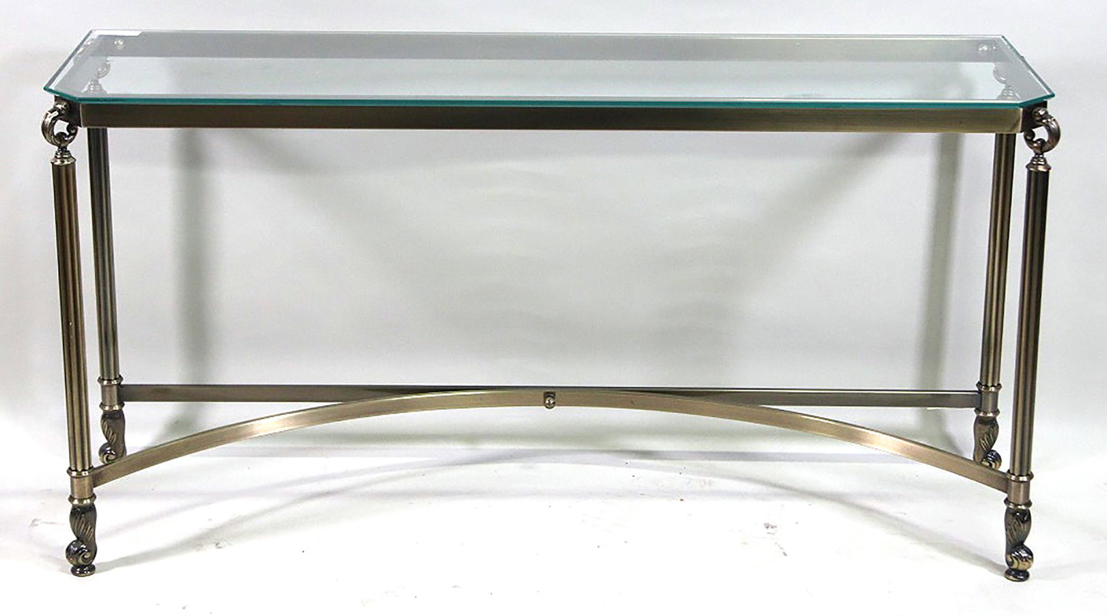 GLASS TOP AND BRASS SOFA TABLE: GLASS TOP AND BRASS SOFA TABLE. Height: 28 in. by Width: 55 in. by Depth: 17