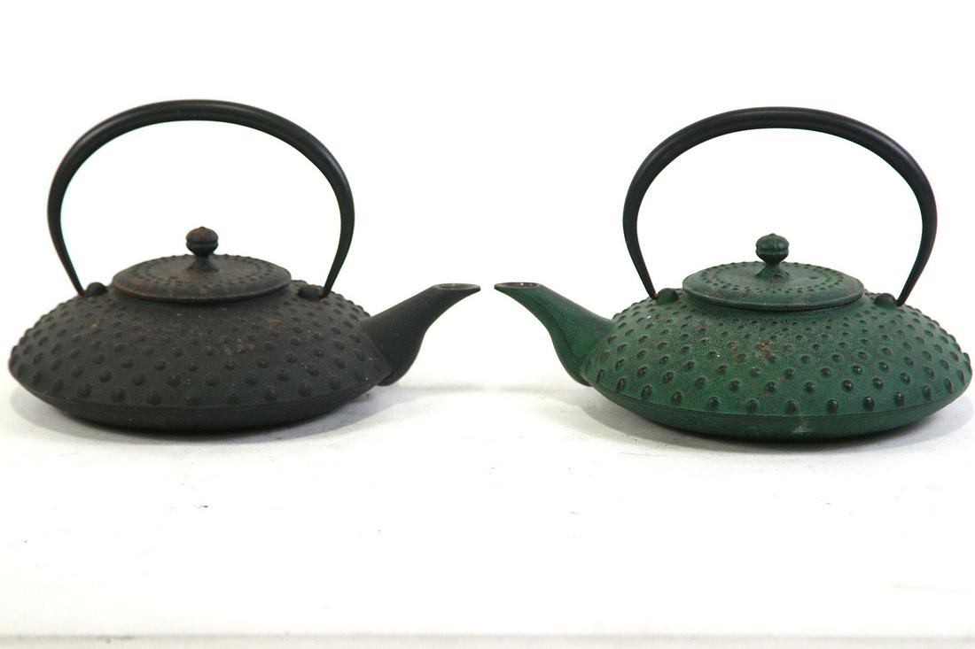 TWO ANTIQUE CAST IRON JAPANESE TEA POTS: TWO ANTIQUE CAST IRON JAPANESE TEA POTS. Height: 7 in. by Width: 10