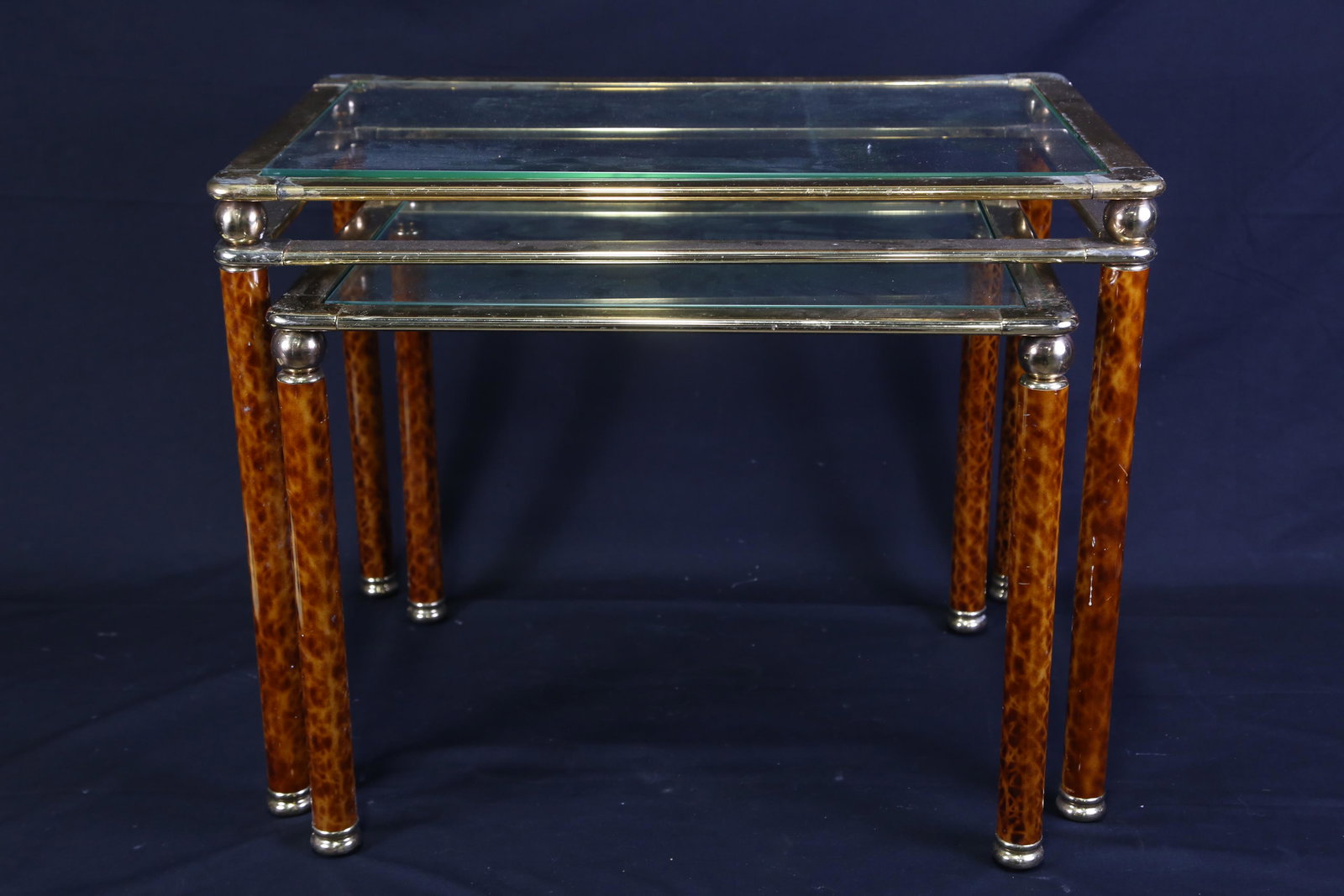 BRASS AND GLASS TWO PIECE NEST OF TABLES: BRASS AND GLASS TWO PIECE NEST OF TABLES. Height: 18 in. by Width: 23 in. by Depth: 16