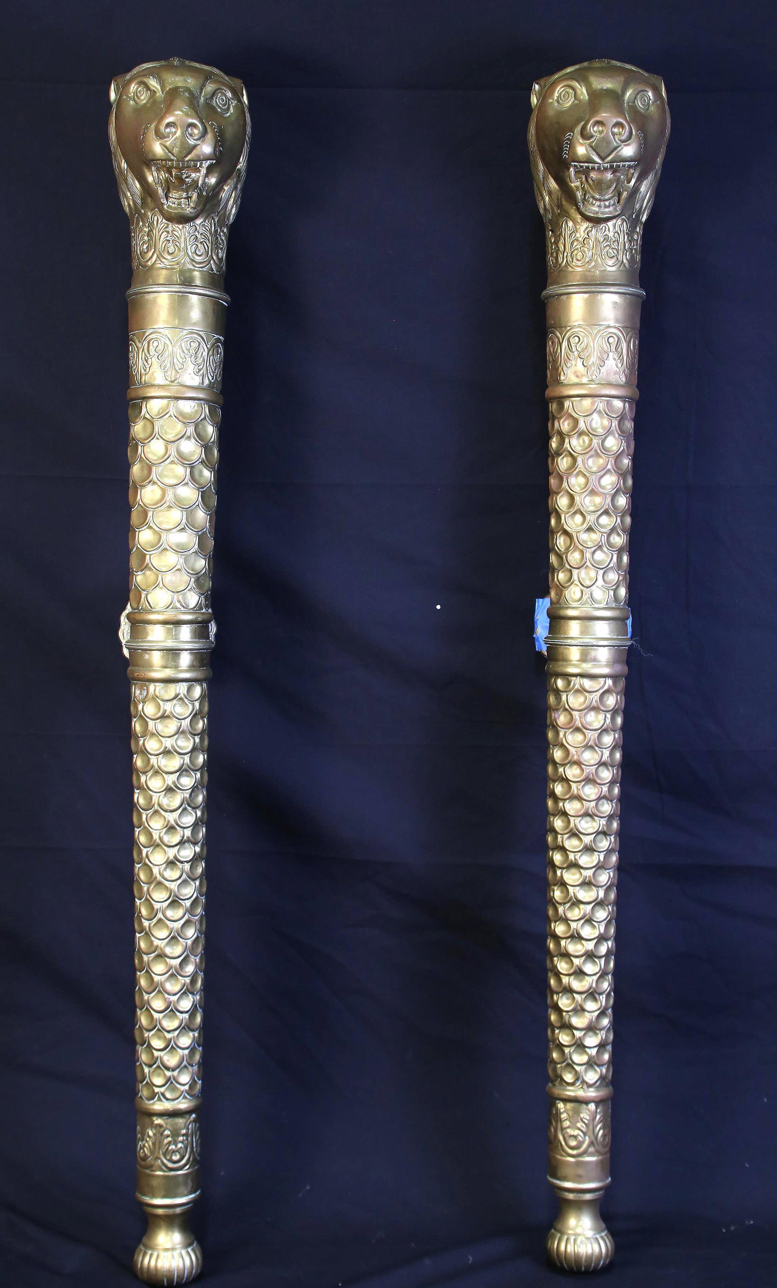 PAIR OF LION HEAD BRASS WALL ORNAMENTS.: PAIR OF LION HEAD BRASS WALL ORNAMENTS. ONE HAS A MISSING MOUNT, SOLD AS IS. 40" long by 7" wide.