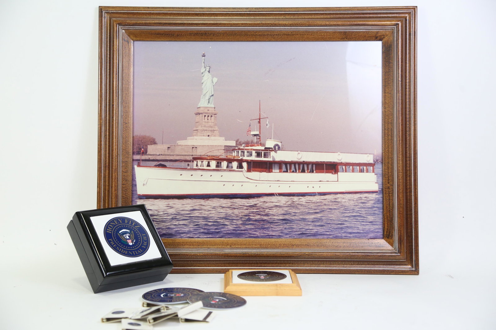 HONEY FITZ PRESIDENTIAL YACHT PHOTO AND MEMORABILI: HONEY FITZ PRESIDENTIAL YACHT PHOTO AND MEMORABILIA OF JOHN F. KENNEDY. CAPTION CAP. COSTERS MATCHES. BOX WITH PRESIDENTIAL SEAL. Height: 21.5 in. by Width: 25