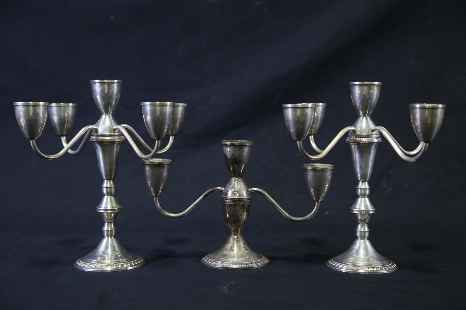 SET OF THREE STERLING SILVER CANDELABRA: SET OF THREE STERLING SILVER CANDELABRA. PAIR AND ONE SMALLER CANDELABRUM. Height: 9.5 in. by Width: 9.5 in. by Depth: 9.5