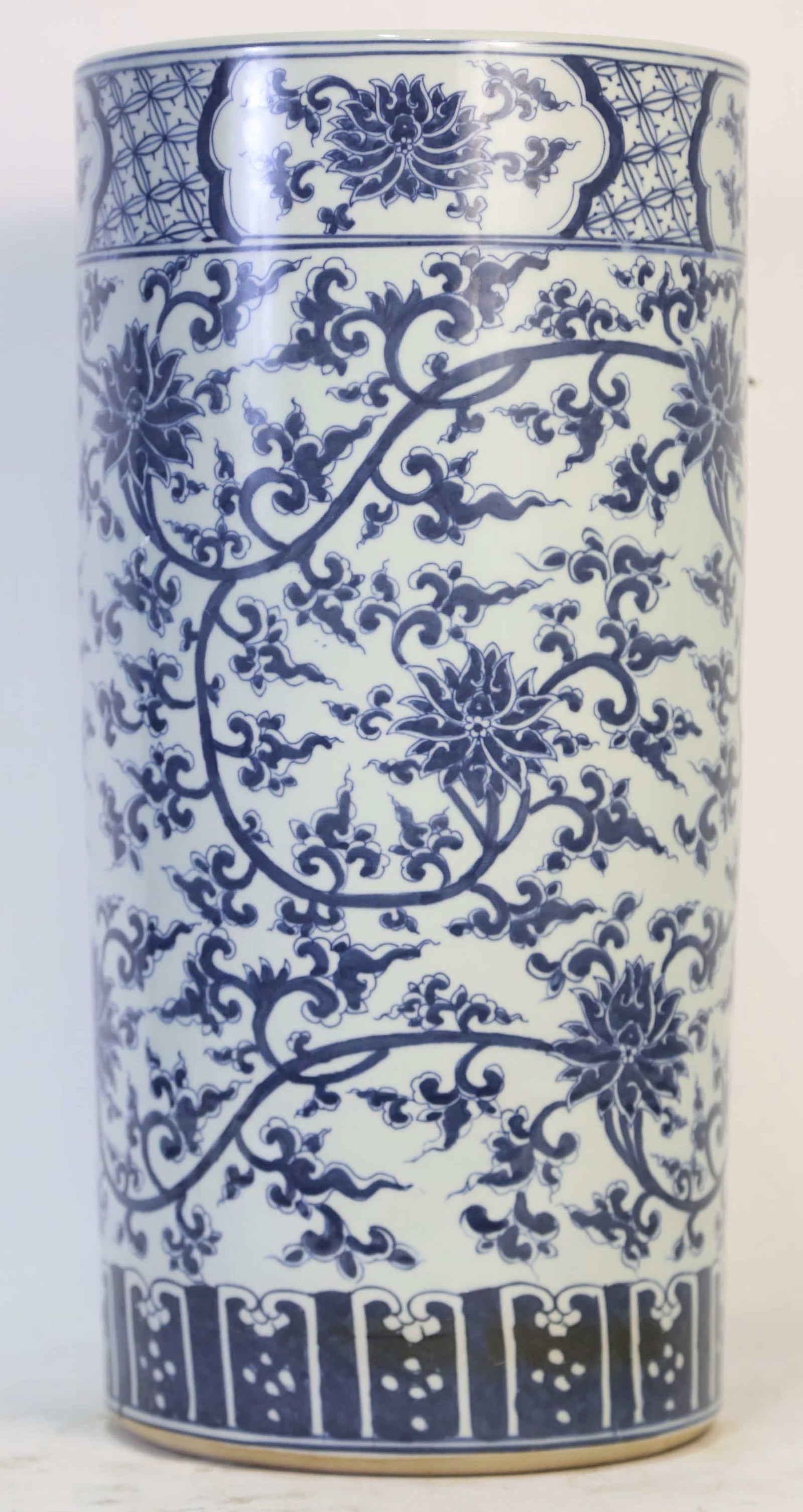 CHINESE BLUE & WHITE LOTUS MOTIF UMBRELLA STAND: CHINESE BLUE & WHITE LOTUS MOTIF UMBRELLA STAND. Height: 21 in. by Width: 10 in. by Depth: 10 in.