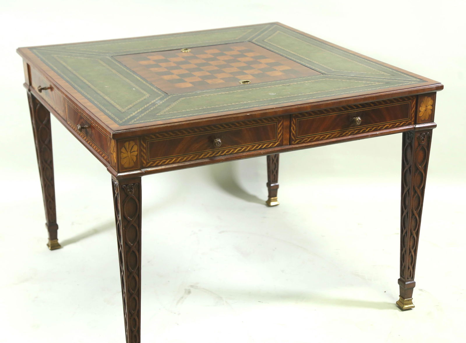 MAITLAND-SMITH GAME TABLE WITH TOOLED LEATHER TOP: MAITLAND-SMITH GEORGIAN STYLE GAME TABLE WITH TOOLED LEATHER TOP AND INLAID WITH CHESSBOARD, FLIPS TO BACKGAMMON, FOUR DRAWERS, INLAID AND CARVED THROUGHOUT. Height: 29.5 by Width: 40.5 by Depth: 40.5