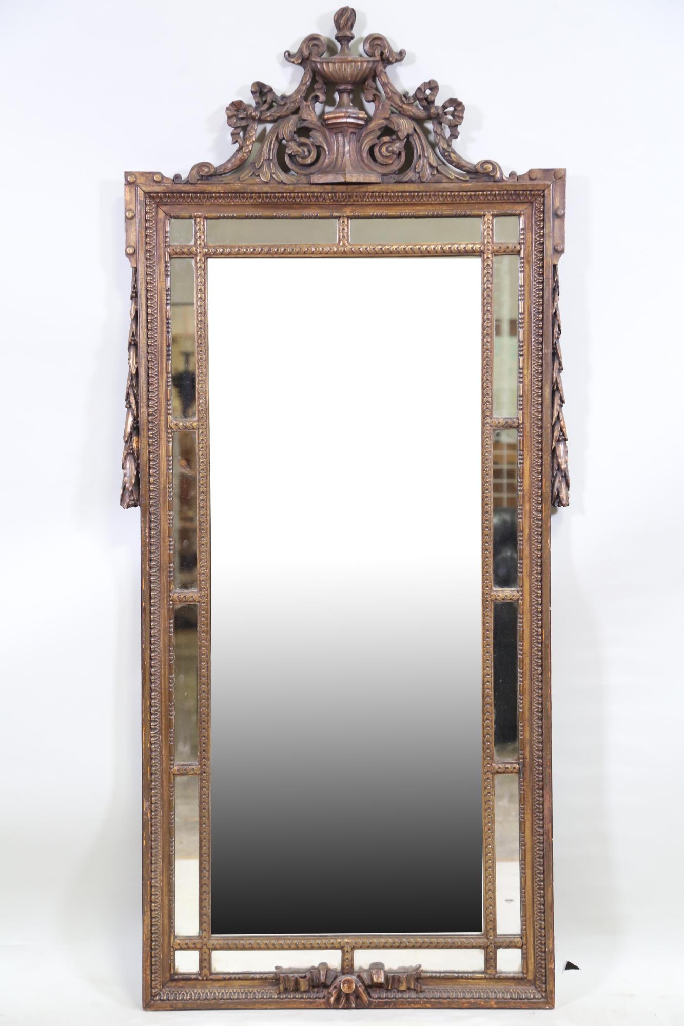 ANTIQUE CARVED AND GILT PANELED MIRROR: ANTIQUE CARVED AND GILT PANELED MIRROR. Height: 63 in. by Width: 28 in.