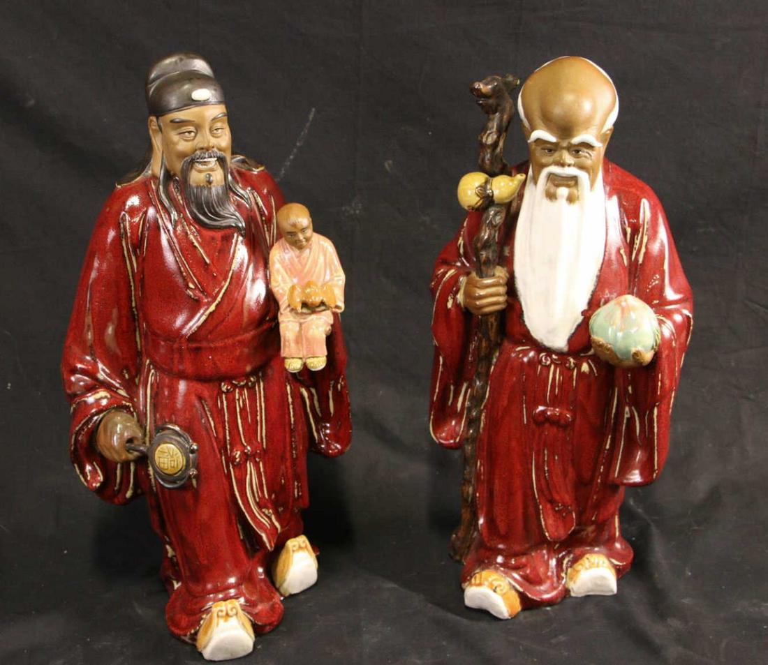 PR. CHINESE SANG DE BOEUF GLAZED PORCELAIN FIGURES: PAIR OF CHINESE SANG DE BOEUF GLAZED PORCELAIN FIGURES. Height: 19 in. by Width: 8.5 in. by Depth: 7 in.