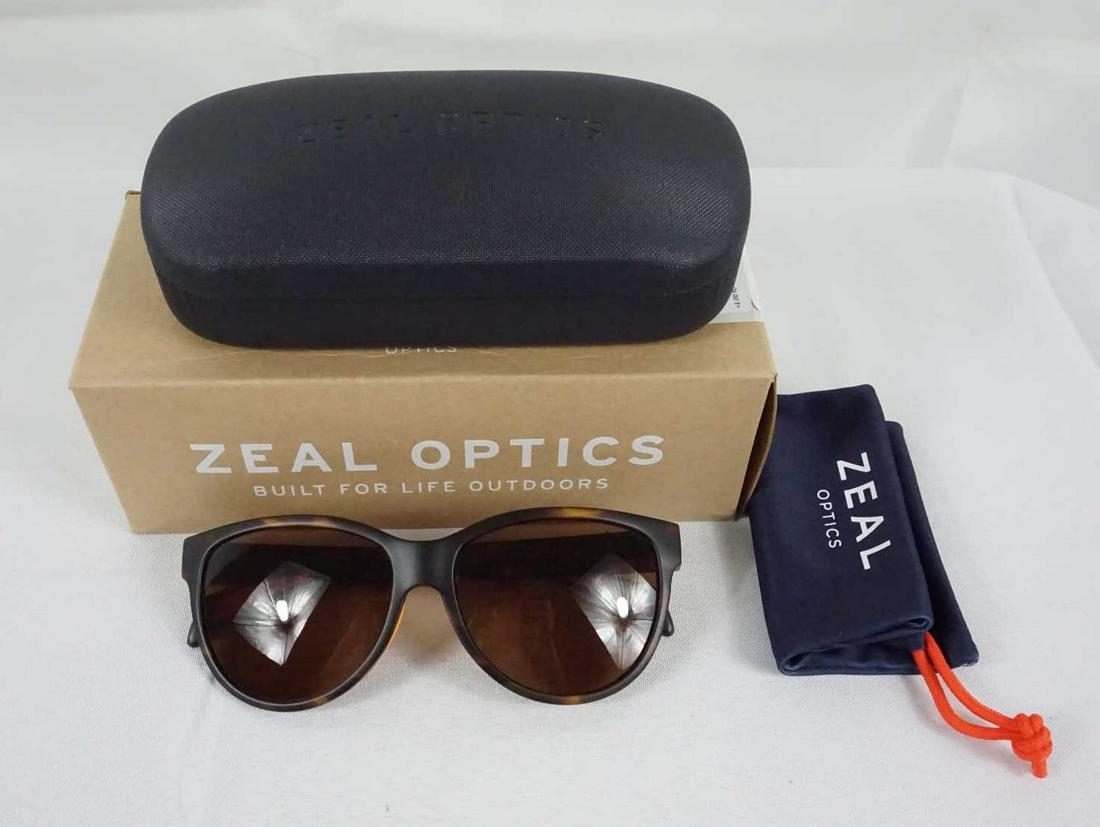 PAIR OF ZAEL OPTICS SUNGLASSES: NEW PAIR OF ZAEL OPTICS SUNGLASSES - POLARIZED LENSES, Z-RESIN BIO-PLASTIC FRAME MATERIAL, A PIN HINGE, AND RX-ABILITY.