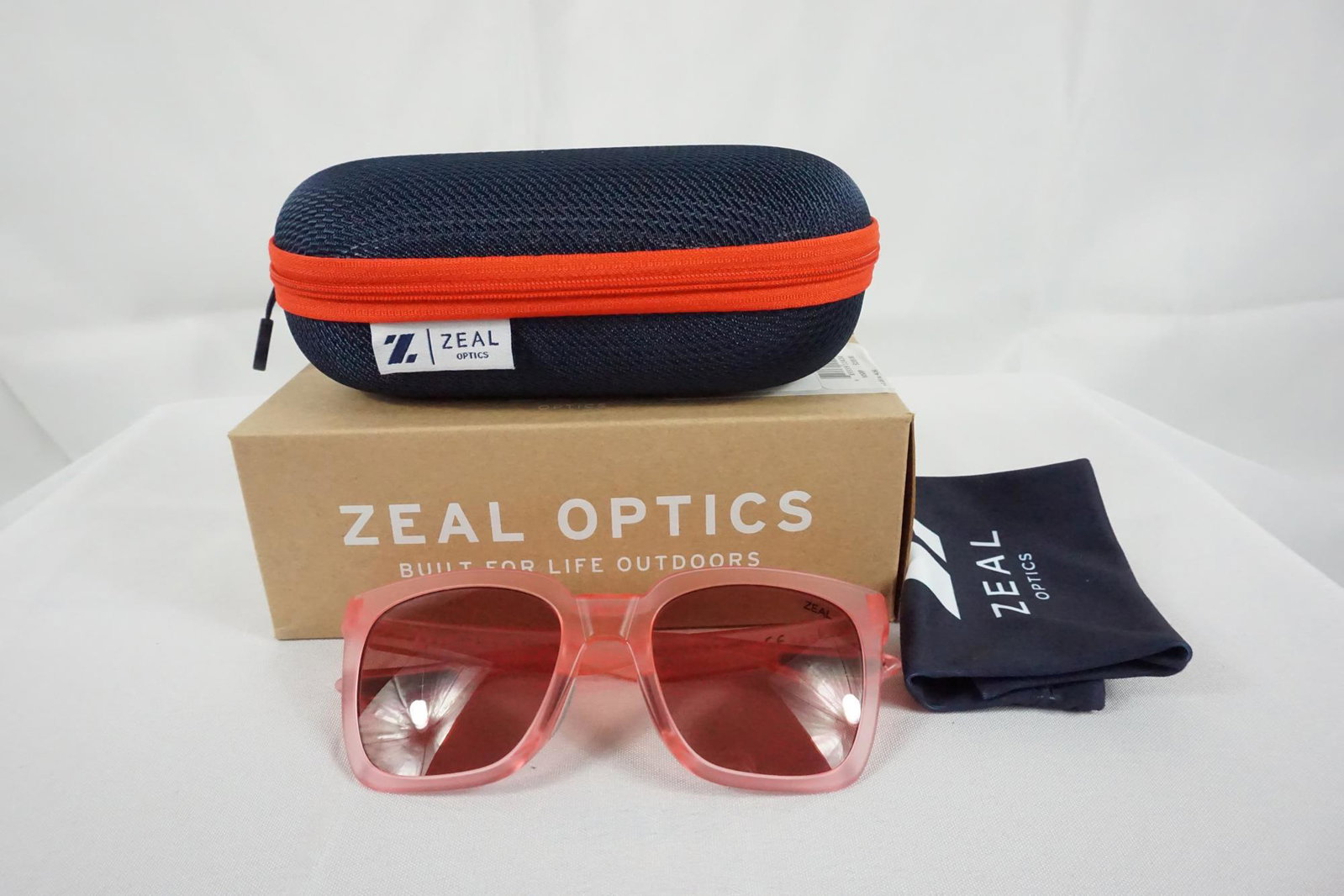 PAIR OF ZAEL OPTICS SUNGLASSES: NEW PAIR OF ZAEL OPTICS SUNGLASSES - FRAME FEATURES: RUBBER NOSEPAD, RUBBER TEMPLES; FRAME MATERIALS: PLASTIC; TEMPLES: BENT