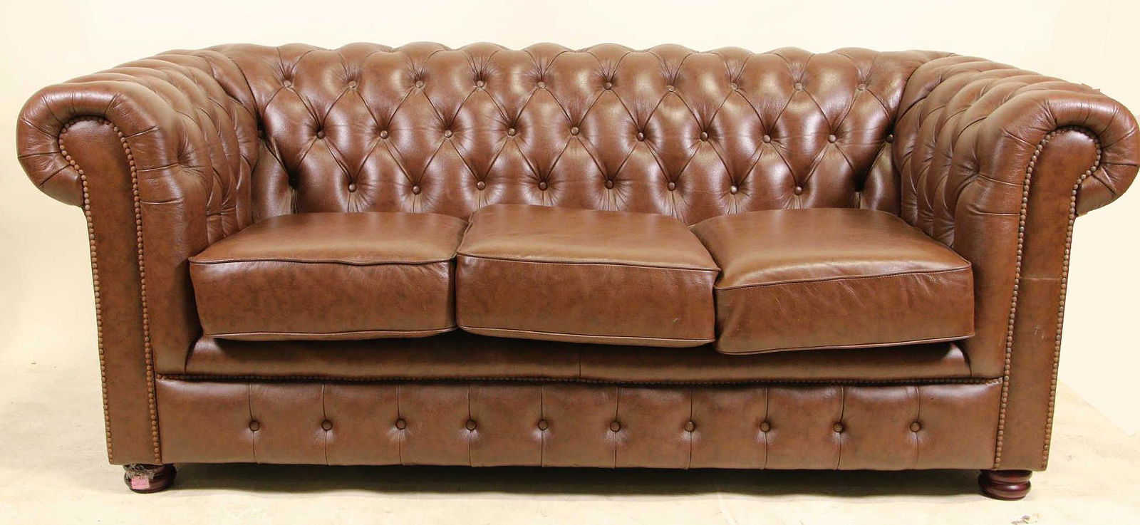 VINTAGE CHESTERFIELD BROWN LEATHER SOFA: VINTAGE CHESTERFIELD BROWN LEATHER THREE CUSHION SOFA. Height: 30 in. by Width: 72 in. by Depth: 34 in.