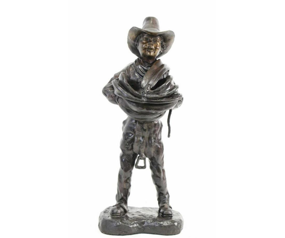 YOUNG COWBOY WITH SADDLE BRONZE SCULPTURE: YOUNG COWBOY WITH SADDLE BRONZE SCULPTURE. Height: 16 in. by Width: 6 in. by Depth: 4 in.