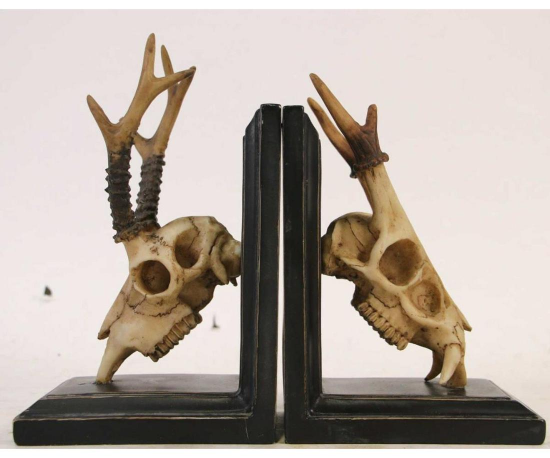 PAIR OF FAUX DEER SKULL BOOKENDS: PAIR OF FAUX DEER SKULL BOOKENDS. Height: 6.5 in. by Width: 3.5 in. by Depth: 5.5 in.