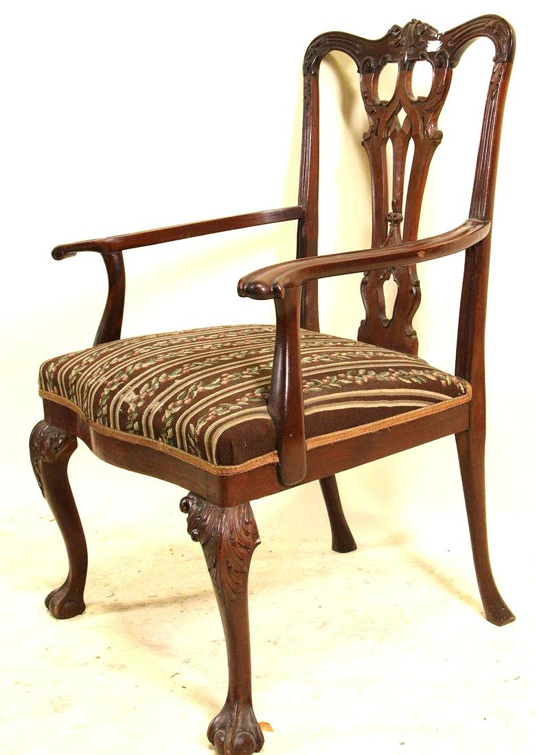 CIRCA 1900's CHIPPENDALE STYLE MAHOGANY ARMCHAIR: CIRCA 1900's CHIPPENDALE STYLE MAHOGANY ARMCHAIR. PART OF KNEE AREA IS MISSING, SOLD AS IS. Height: 38.5 in. by Width: 26 in. by Depth: 20.5 in.