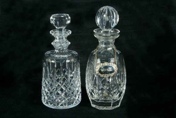 TWO HAND-CUT CRYSTAL WATERFORD DECANTERS: TWO HAND-CUT CRYSTAL WATERFORD DECANTERS. Height: 10 1/2 and 7 1/2 in. by Width: 4 and 7 in. by Depth: 4 and 7 in.