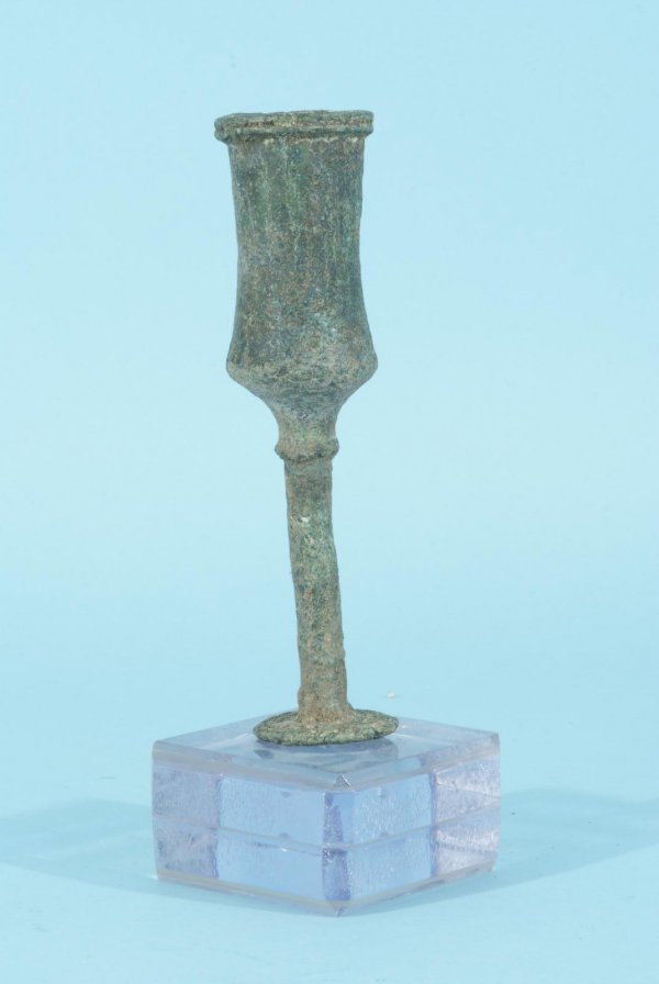 1800 B. C. PERSIAN BRONZE VESSEL: 1800 B. C. PERSIAN BRONZE VESSEL WITH PLEXIGLASS BASE. LOST WAX CAST OPEN HANDLE FROM A SCEPTER SHAPED LIKE VESSEL, THIN NECK WITH FLAT TRUMPET RIM, GREEN OXIDATION OVER ENTIRE SURFACE Height: 6 in. b