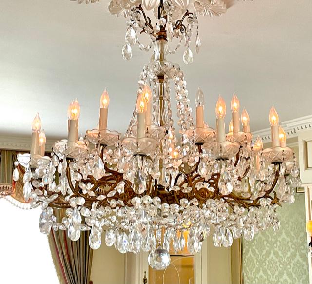 CRYSTAL AND GILT BRONZE 22 LIGHT CHANDELIER: ANTIQUE CRYSTAL AND GILT BRONZE 22 LIGHT CHANDELIER. PROVENANCE: NEW ORLEANS LIGHTING & ANTIQUES, NEW ORLEANS, LOUISIANA. 33"h x 36"w.