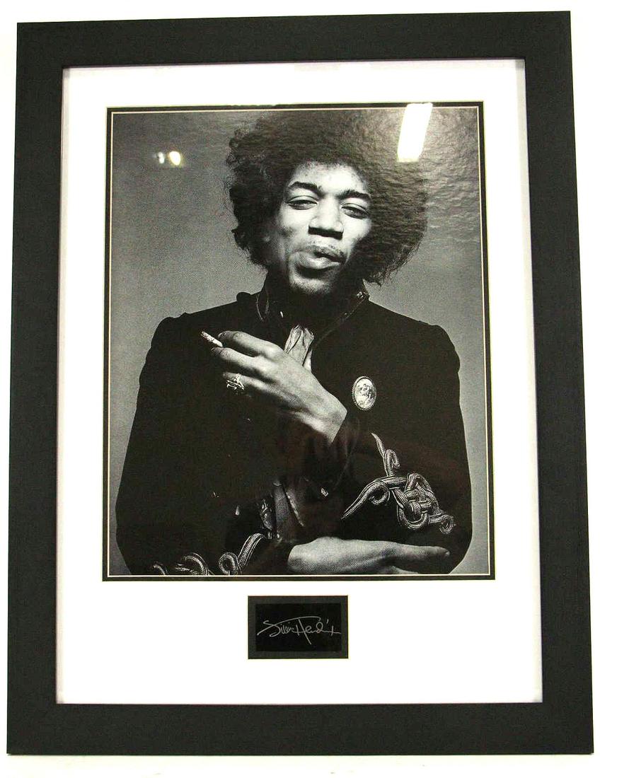 FRAMED JIMI HENDRIX PHOTOGRAPH: FRAMED JIMI HENDRIX PHOTOGRAPH. SIGNATURE IN PLATE. Height: 30.5 in. by Width: 23.5 in.