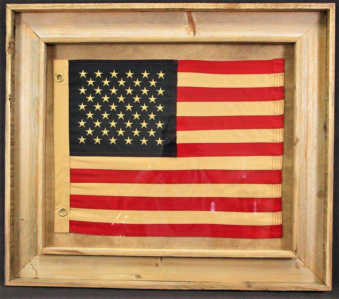 FRAMED HANDSTITCHED CANVAS AMERICAN FLAG: FRAMED HANDSTITCHEDAMERICAN FLAG. Height: 27 in. by Width: 30 in.
