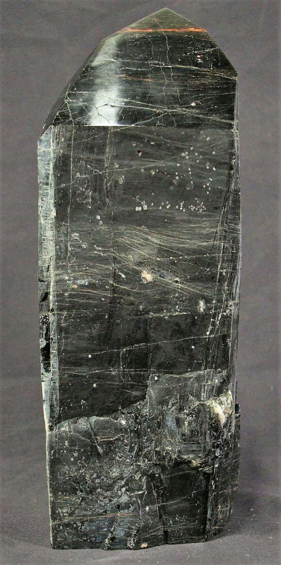TOURMALINE & HEMATITE POINT W/POLISHED TIP: TOURMALINE & HEMATITE POINT W/POLISHED TIP - (T18) 12.8 LBS. Height: 13 in. by Width: 4 in. by Depth: 4 in.