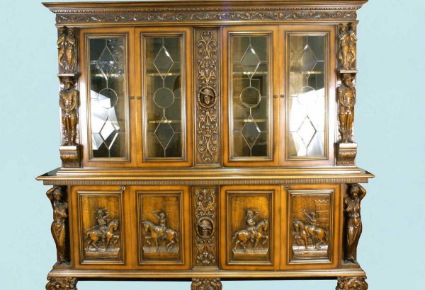 RENAISSANCE REVIVAL WALNUT CARVED BOOKCASE: RENAISSANCE REVIVAL WALNUT CARVED BOOKCASE & CREDENZA WITH CAVALIER MOTIF. Height: 94 in. by Width: 106 1/2 in. by Depth: 20 1/2 in.