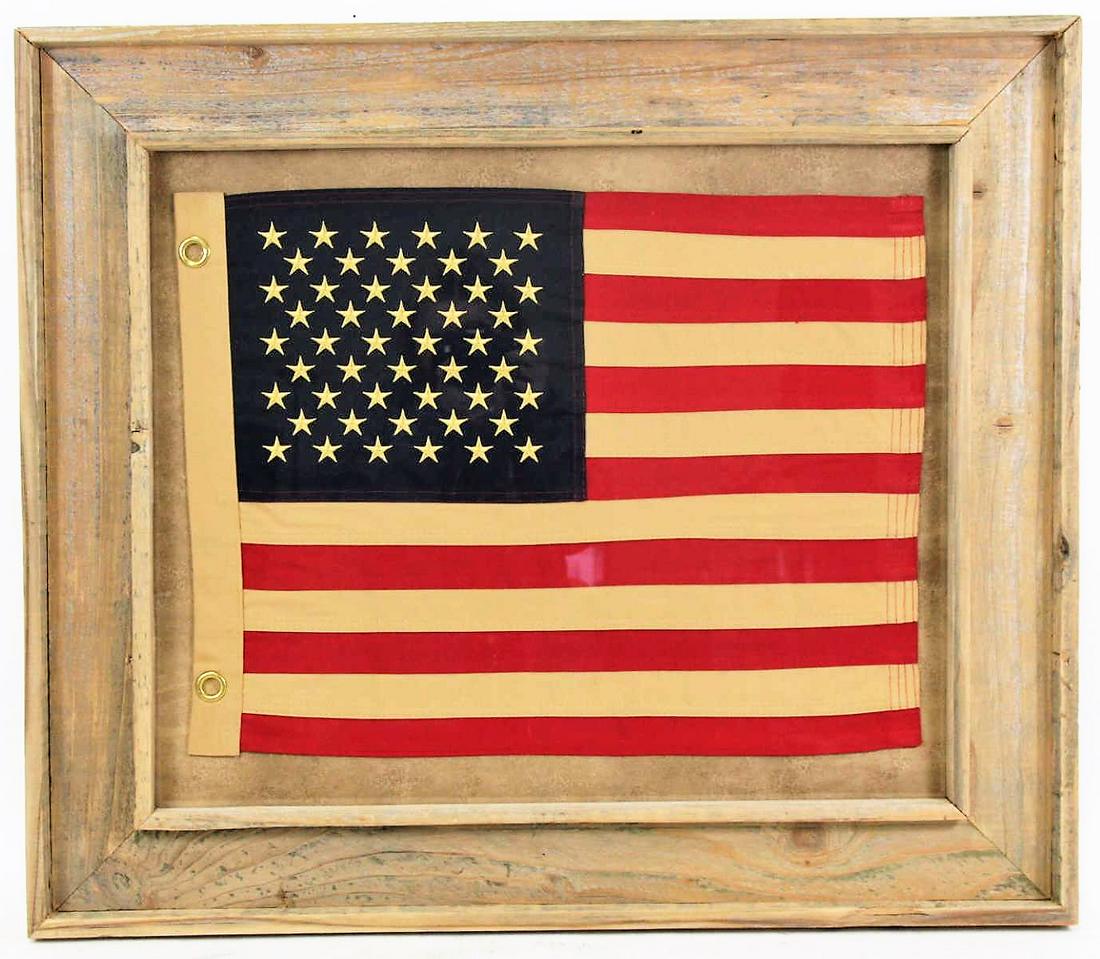 FRAMED UNITED STATES OF AMERICA CLOTH FLAG: FRAMED UNITED STATES OF AMERICA CLOTH FLAG. Height: 26 in. by Width: 30 in.