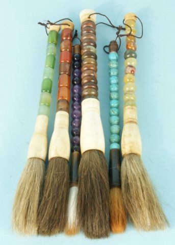 SIX SEMI-PRECIOUS STONE HORSEHAIR BRUSHES: SIX SEMI-PRECIOUS STONE HORSEHAIR BRUSHES. AMETHYST, JADE, STONE BALLS, BROWN STONES, AND TWO TURQUOISE BALLS. Height: 12 in. by Width: 1 1/2 in. by Depth: 1 1/2 in.